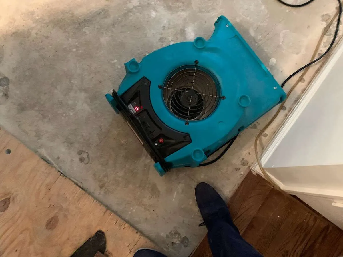 Air mover drying subfloor during Leak Detection & Repair in Oswego